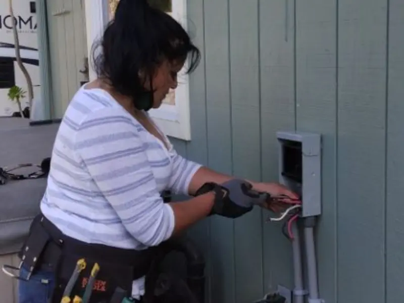 Licensed electrician wiring an exterior subpanel in Lamar